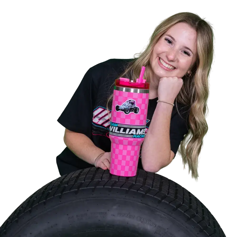 Ashley Williams leaning on sprint car tire with pink Ashley Williams Racing tumbler